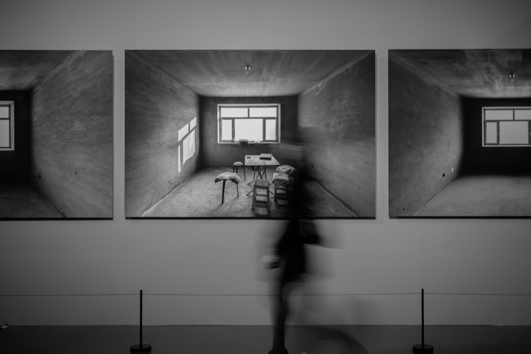 Photographer reviewing black and white documentary prints on a light table